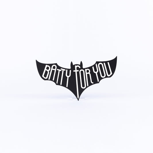 Black bat-shaped sign with 'Batty For You' white text on a white background