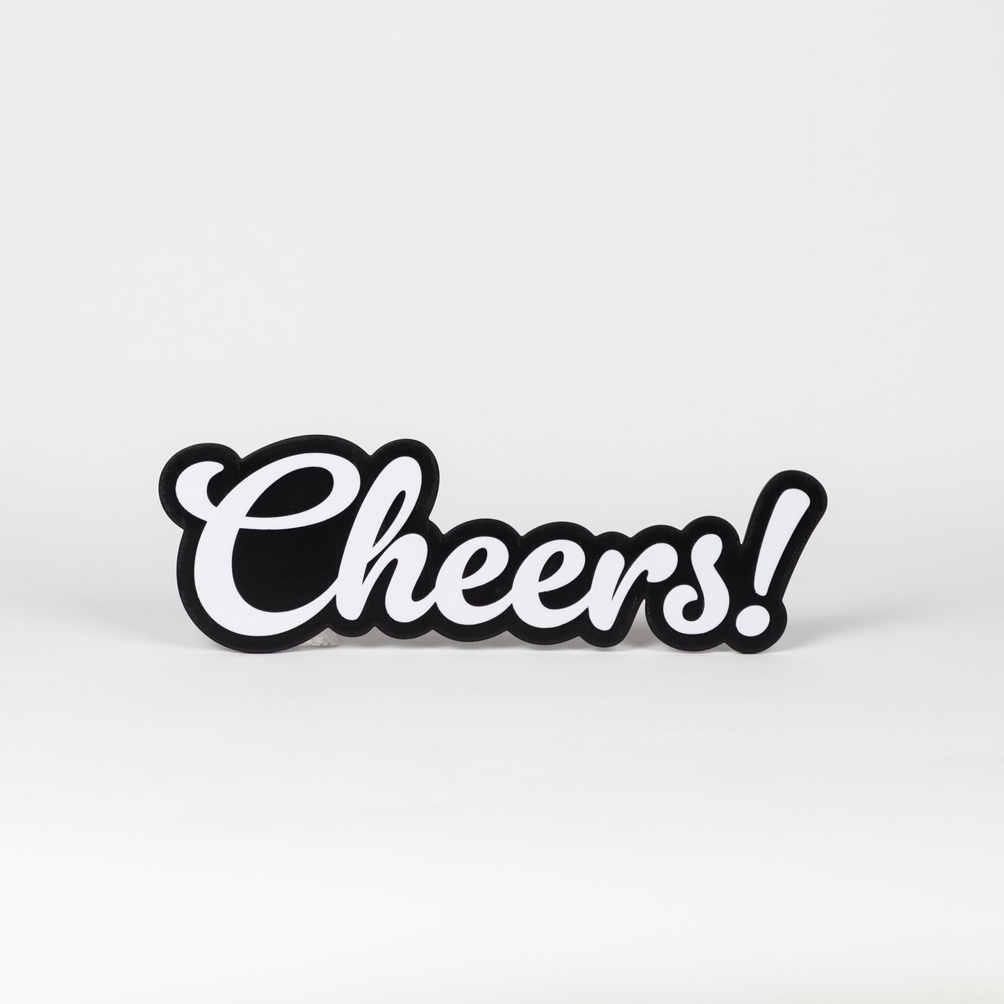 Black and white 'Cheers!' sign on a light gray background