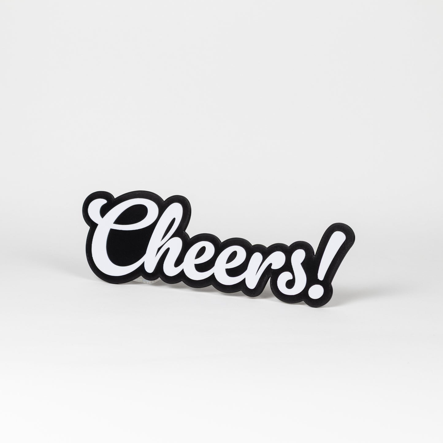 Black and white photo booth sign with 'Cheers!' text on a white background