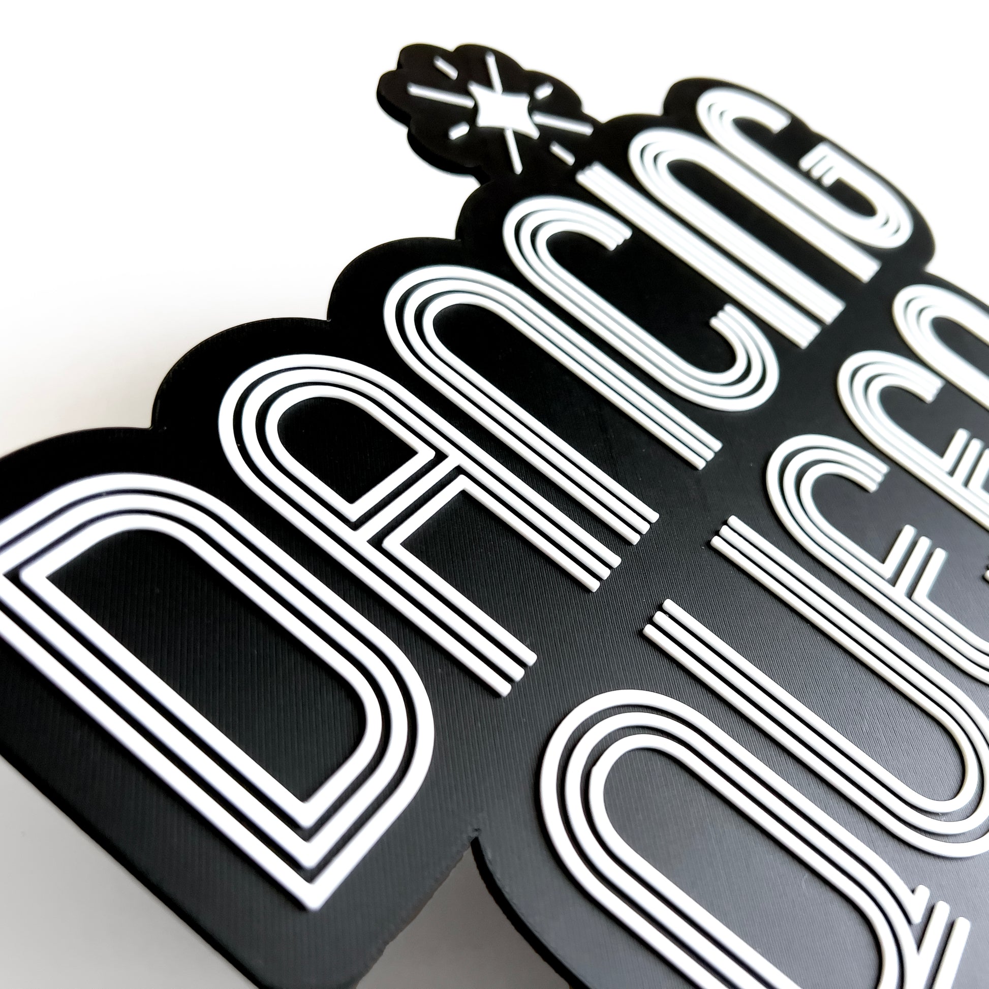 Close up of a black and white sign photo booth prop that says "Dancing Queen"