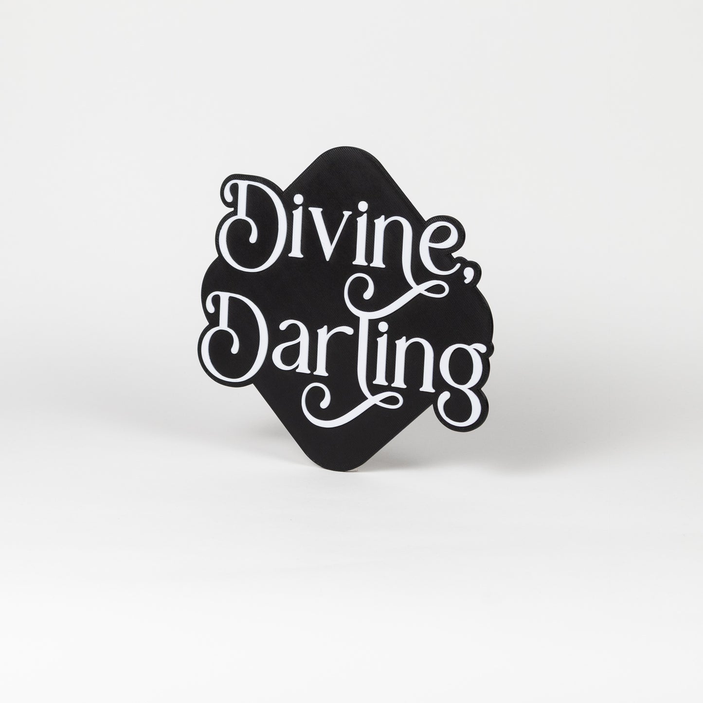 Black and white 'Divine Darling' sign on a white background