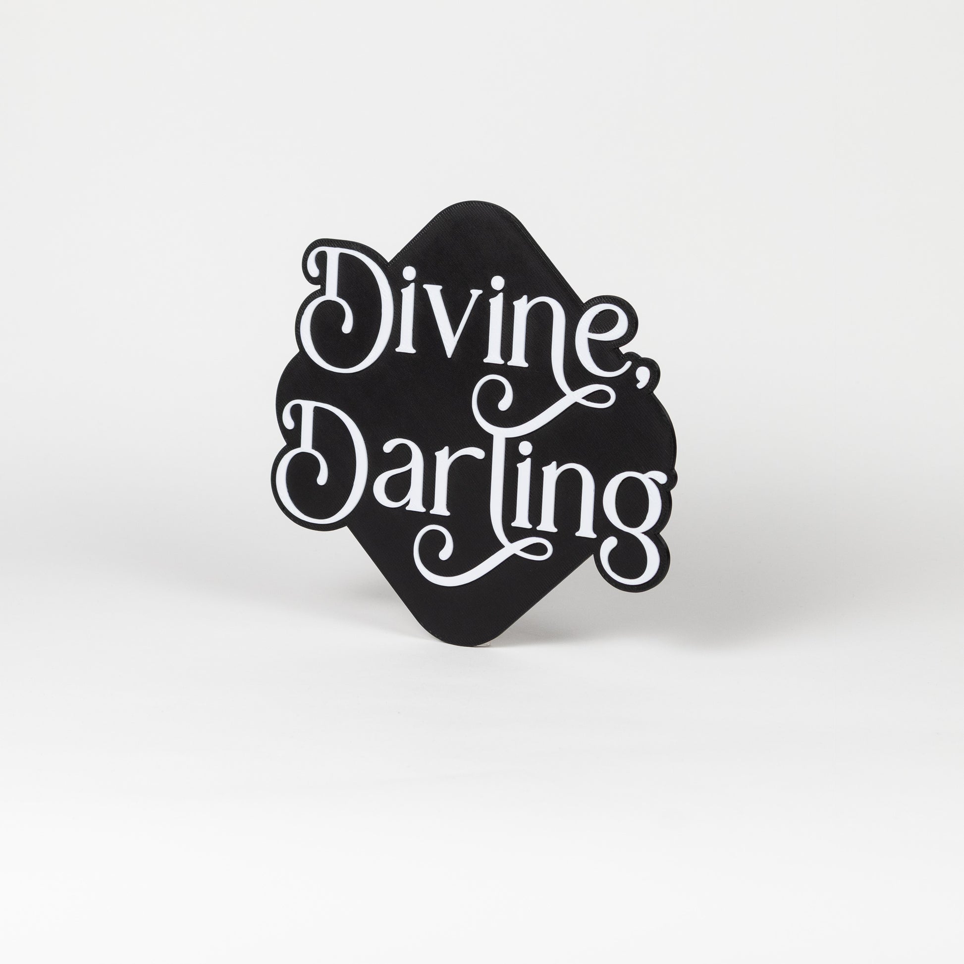 Black and white 'Divine Darling' sign on a white background