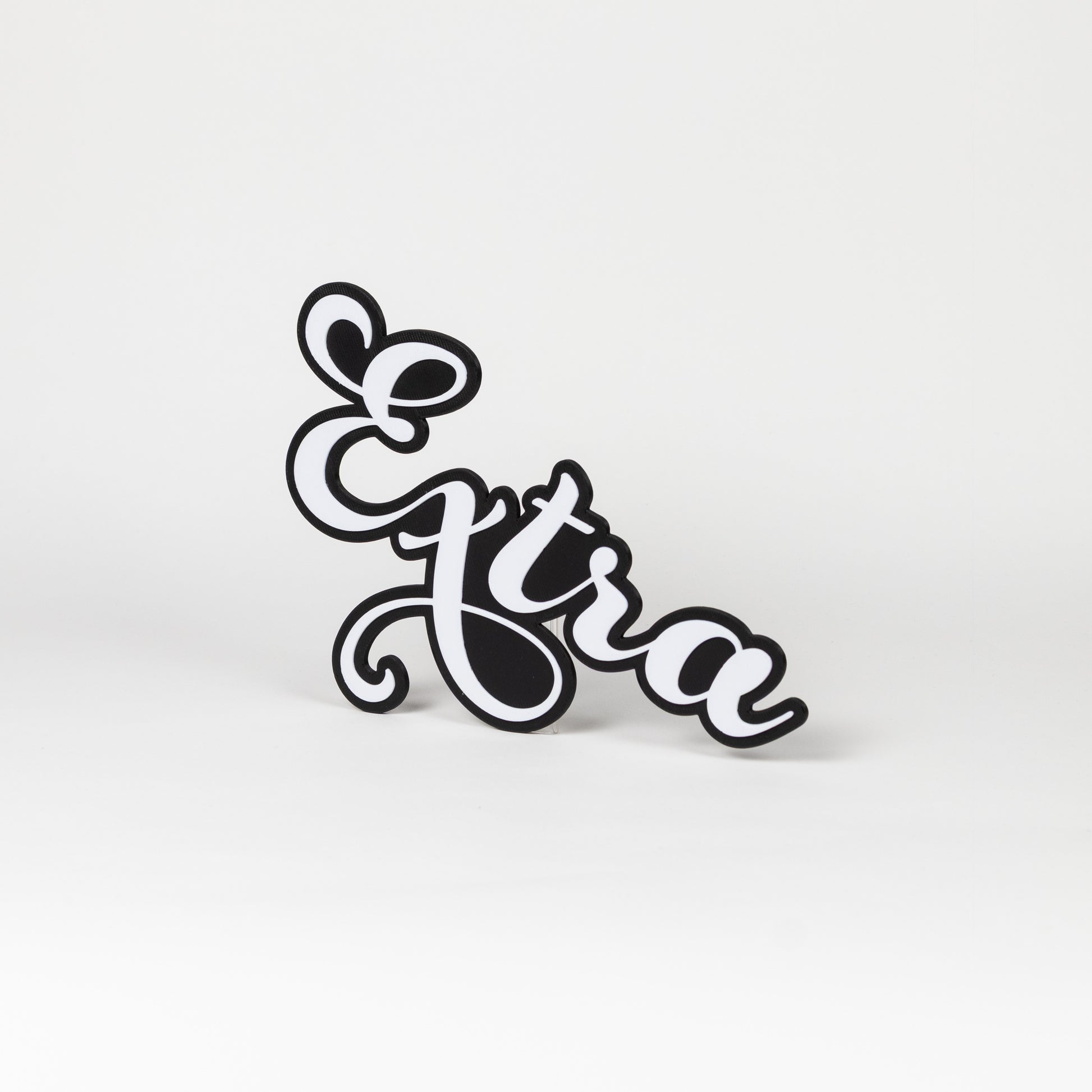 Photo booth prop sign 'Extra', white letters with a black outline on a white background