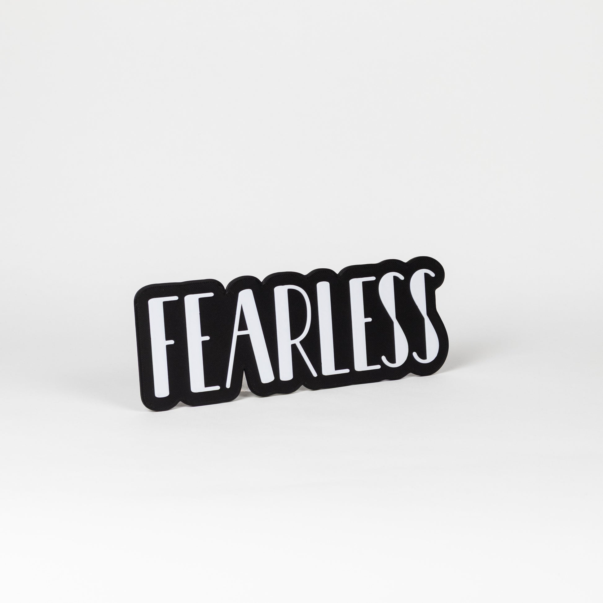 Black and white 'FEARLESS' prop sign on a white background