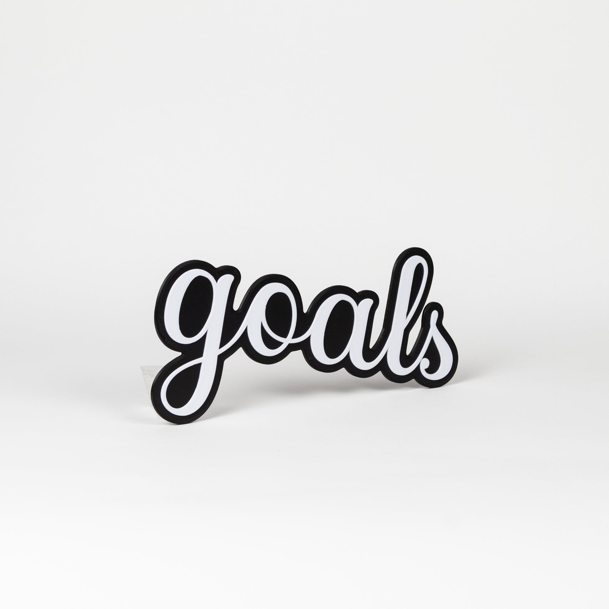 Black and white photo booth prop 'goals' on a white background