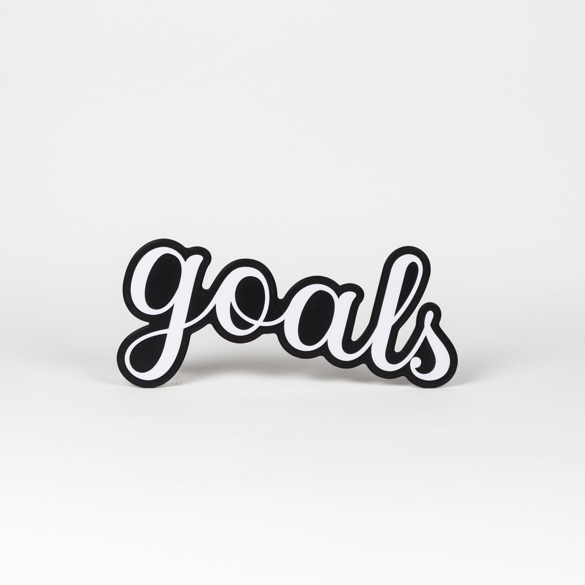 Black and white 'goals' prop on a light gray background