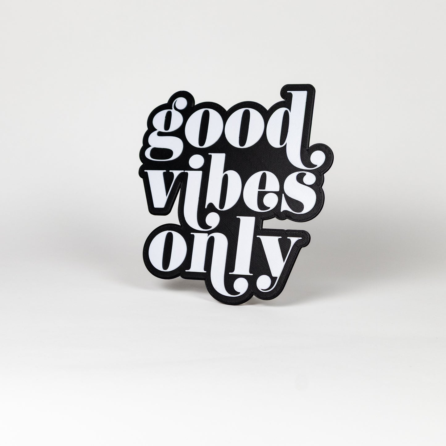 Photo booth prop sign with 'good vibes only' text on a white background