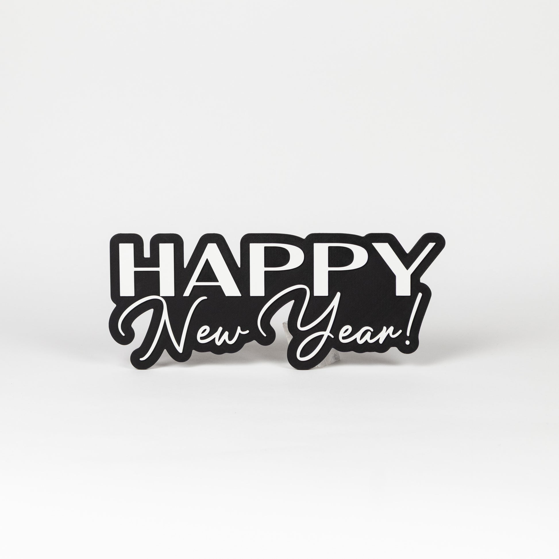 Photo booth prop sign with 'Happy New Year!' text on a black base. Shot on a white background