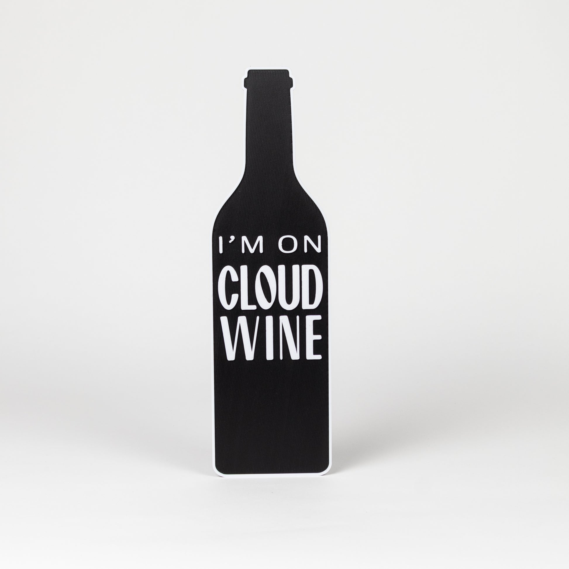 Black wine bottle-shaped sign with 'I'm on Cloud Wine' text on a white background