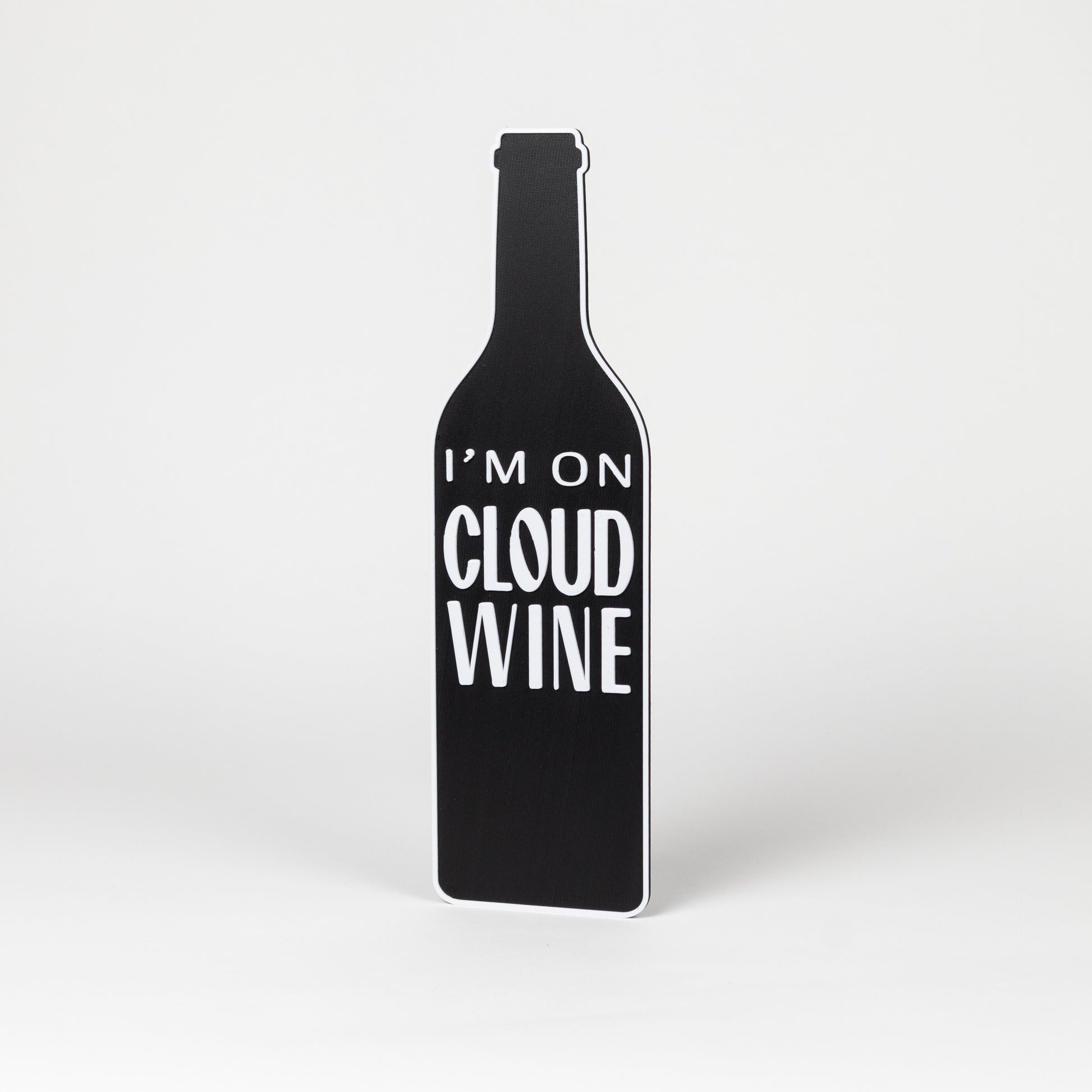 Photo booth prop. Black wine bottle-shaped sign with 'I'm on Cloud Wine' text on a white background