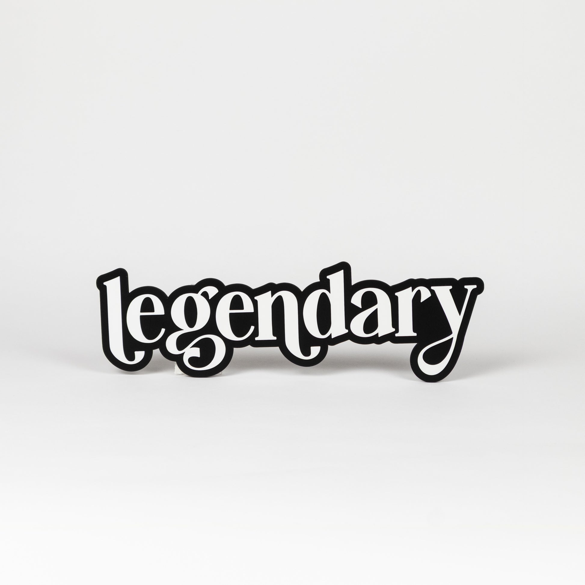 Photo booth prop sign. Black base with white 'legendary' text on a white background