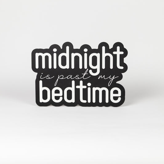 Photo booth prop sign. Black base with 'midnight is past my bedtime' white text on a white background