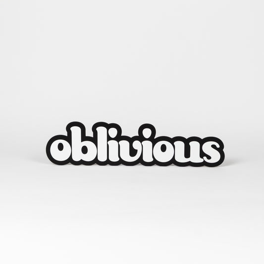 Black and white photo prop of the word 'oblivious'. 
