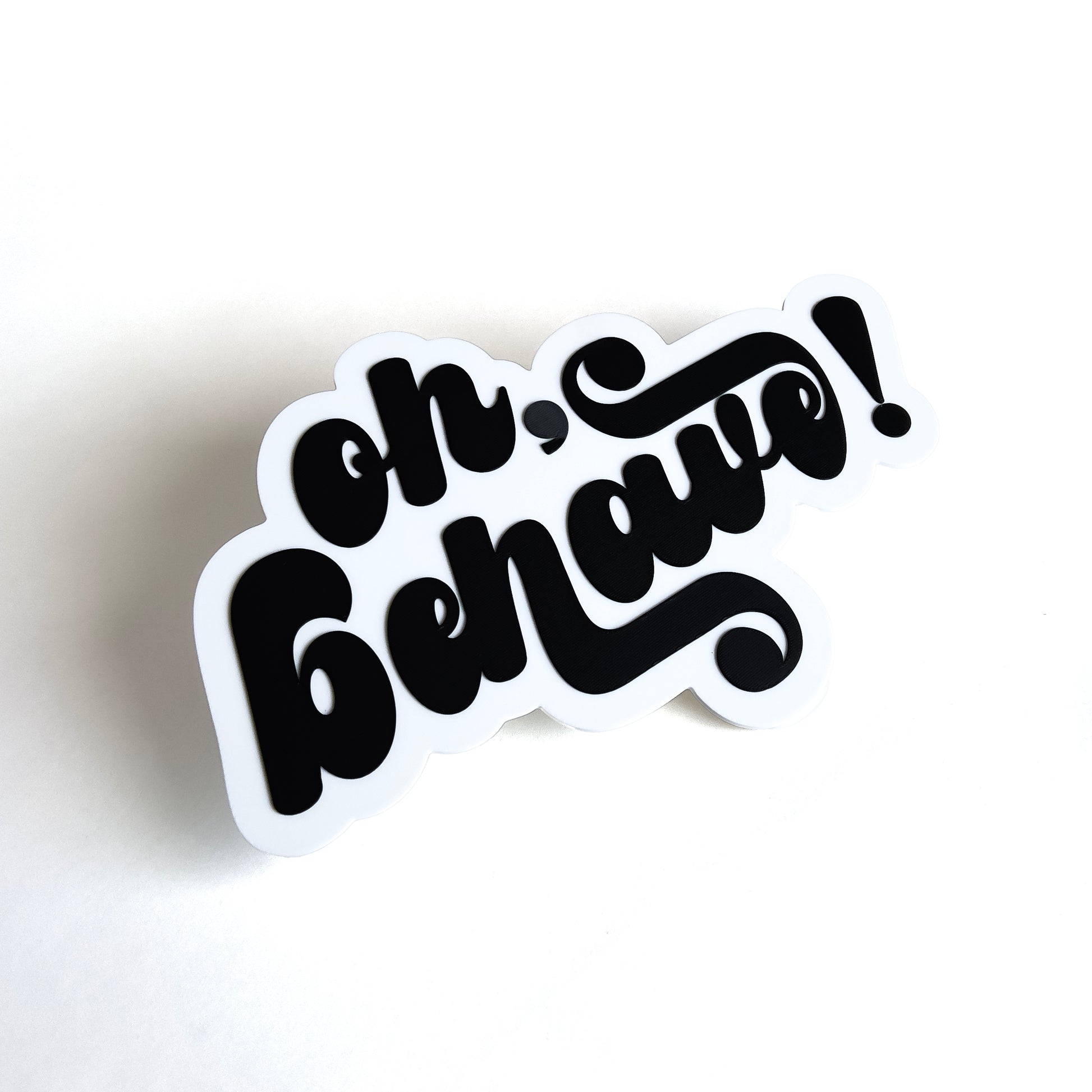 White and black photo booth prop sign that says "oh, behave!".
