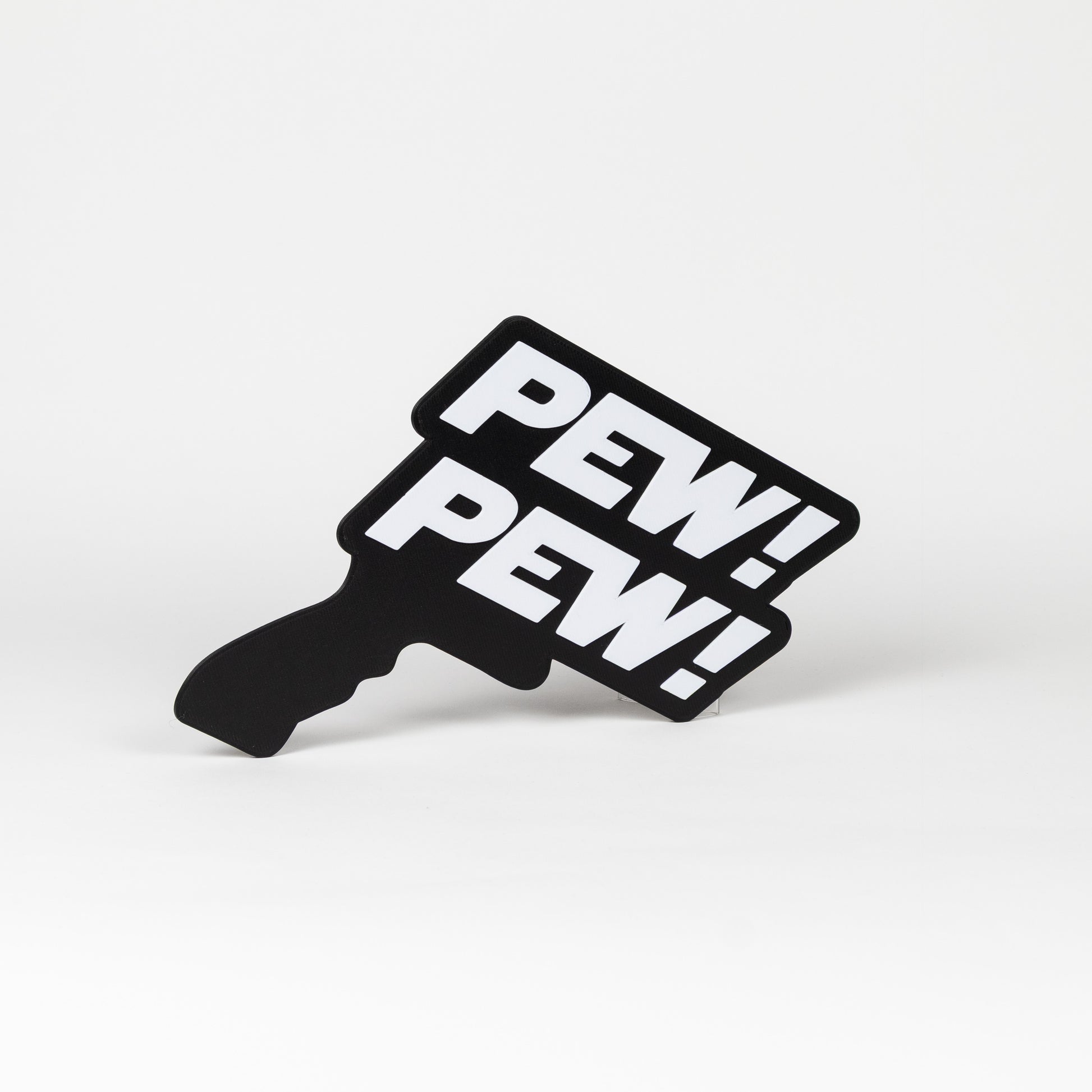 Black and white sign that says "Pew Pew!". Sign is in the shape of a Star Wars blaster. Photo booth prop.