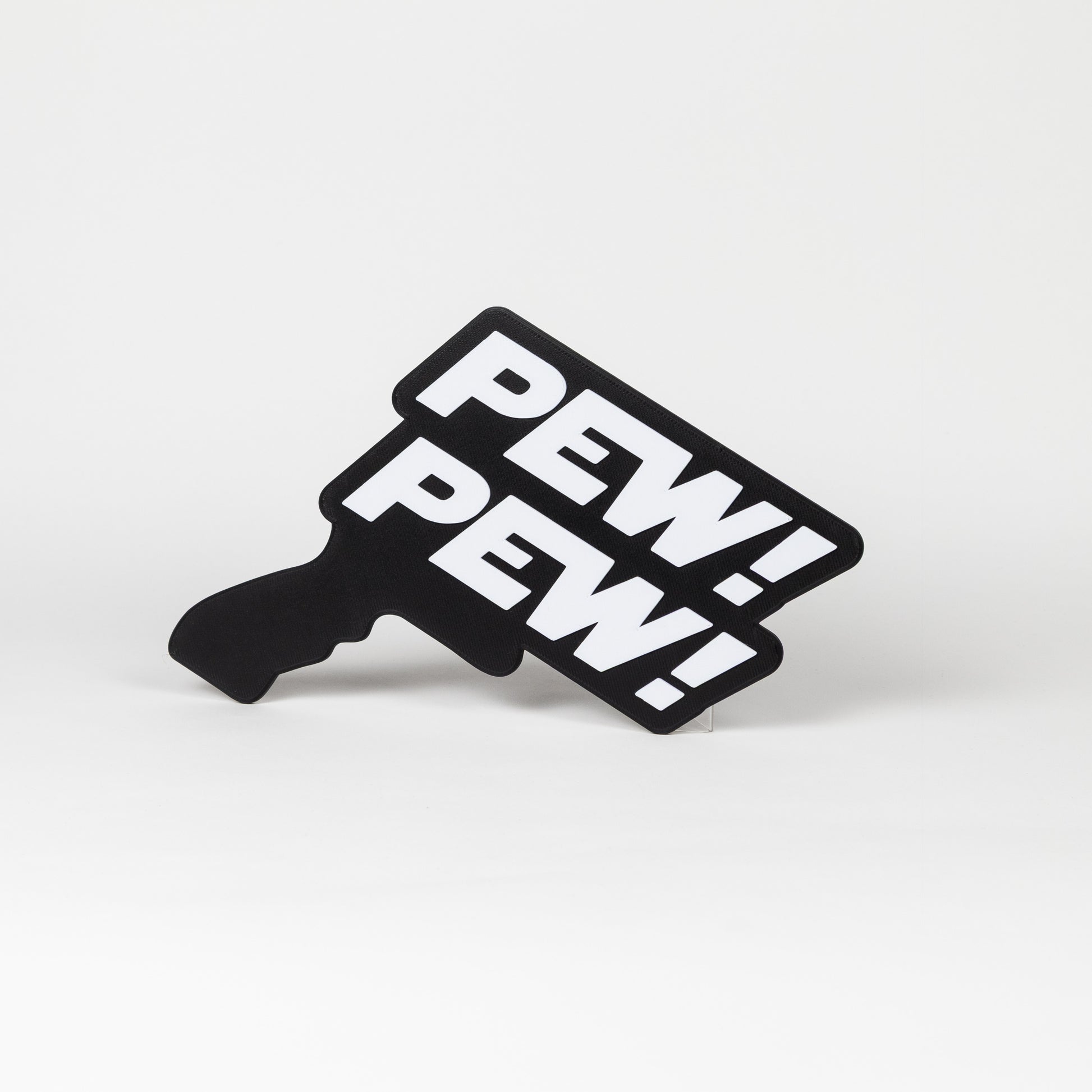 Black and white sign that says "Pew Pew!". Sign is in the shape of a Star Wars blaster. Photo booth prop.