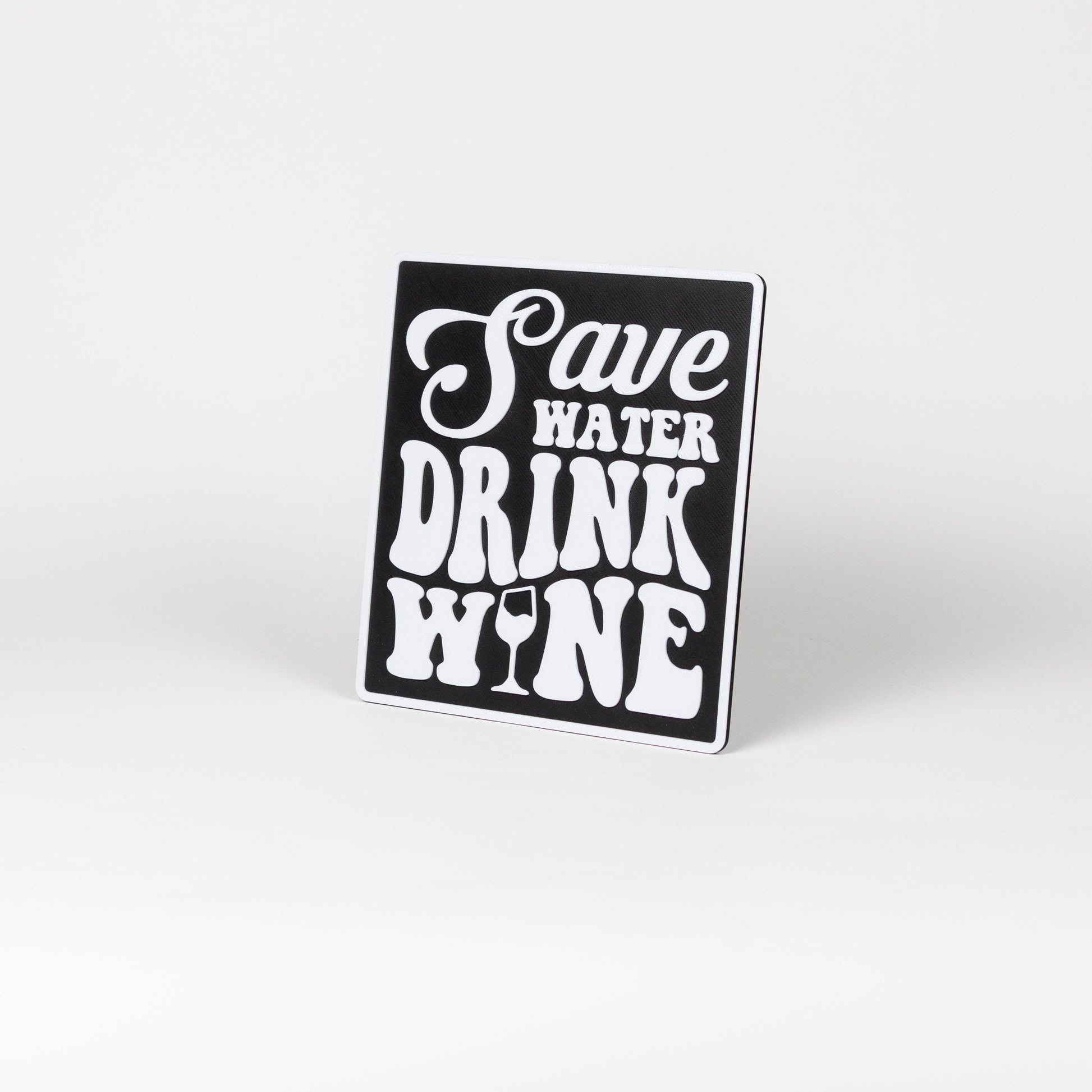 Black and white sign that says, "Save Water, Drink Wine". Photo booth prop.