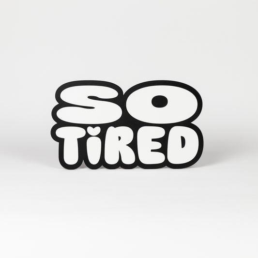 Black and white "So Tired" sign. Photo booth prop.