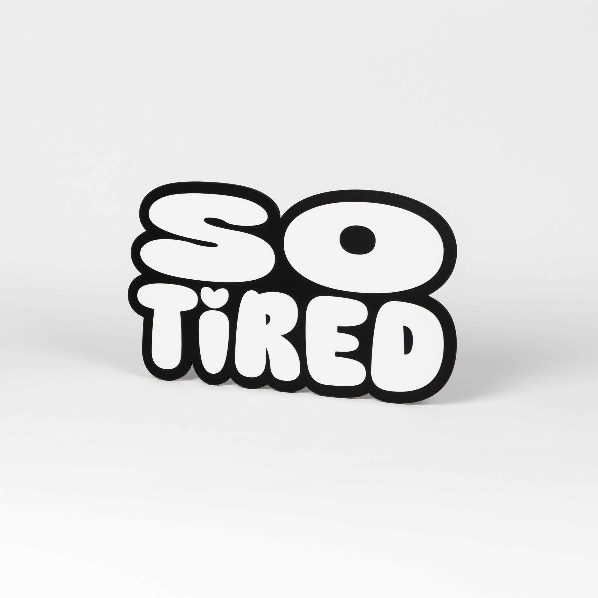 Black and white "So Tired" sign. Photo booth prop.