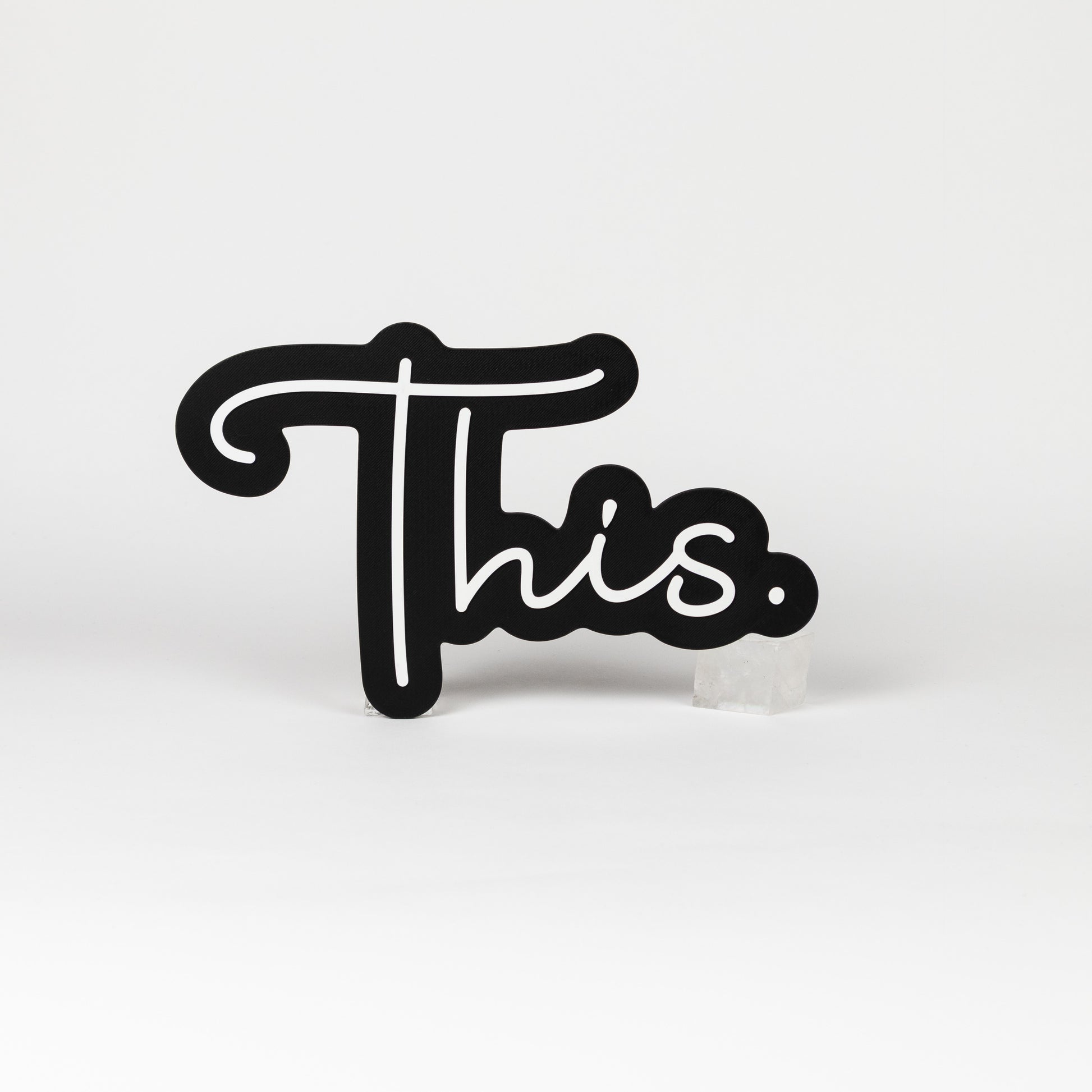 Black and white sign of the word "This." Photo booth prop of popular saying.