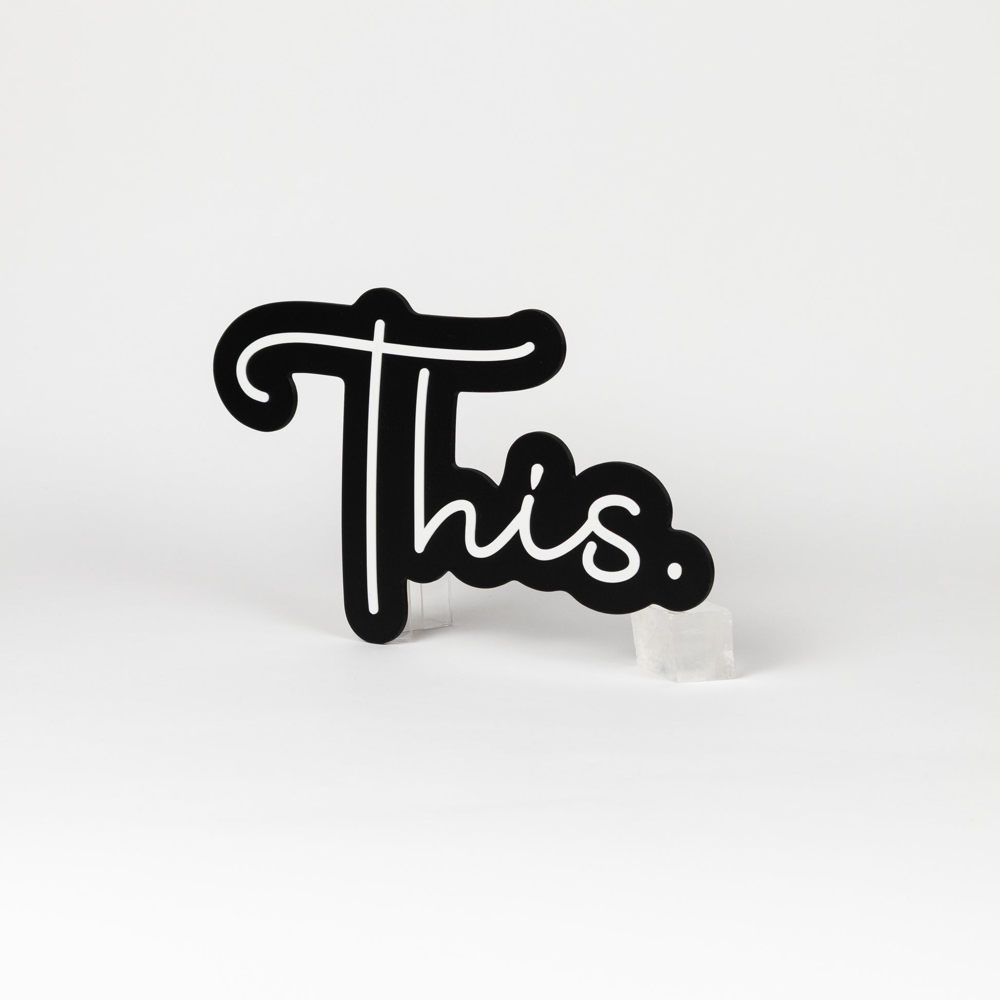 Black and white sign of the word "This." Photo booth prop of popular saying.