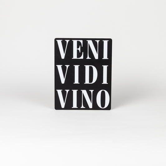 Black sign with white text 'VENI VIDI VINO' shot on a white background